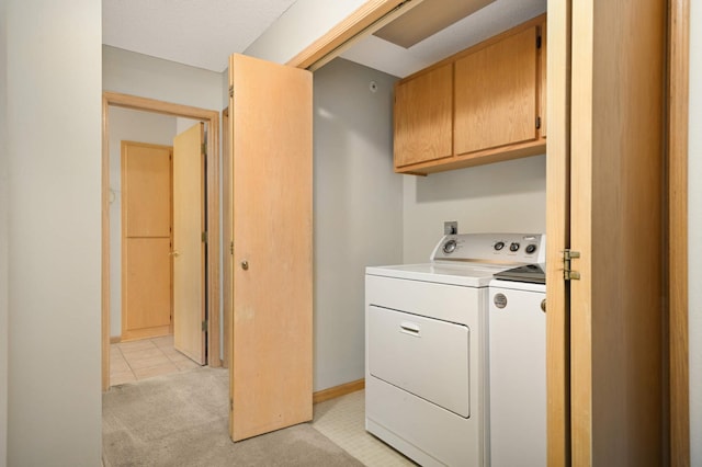 washroom with separate washer and dryer, light colored carpet, cabinet space, and baseboards