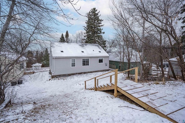 view of snow covered rear of property