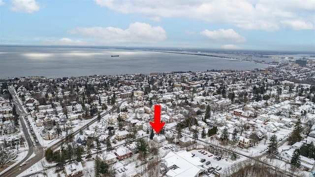 snowy aerial view featuring a water view