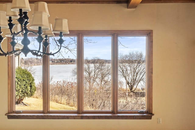 interior space featuring a water view and an inviting chandelier