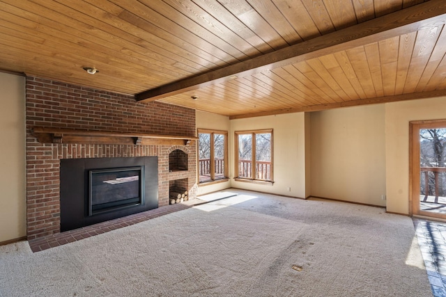 unfurnished living room with wood ceiling, a fireplace, and a wealth of natural light