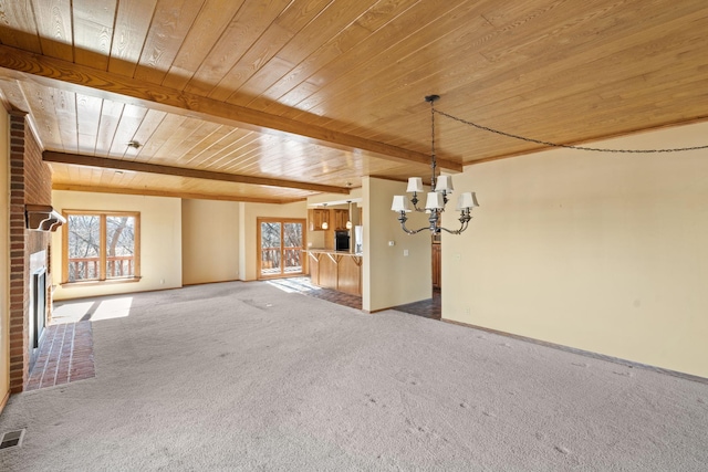 interior space with a chandelier, wooden ceiling, a fireplace, visible vents, and carpet