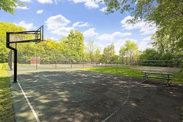 view of sport court featuring a tennis court, community basketball court, and fence