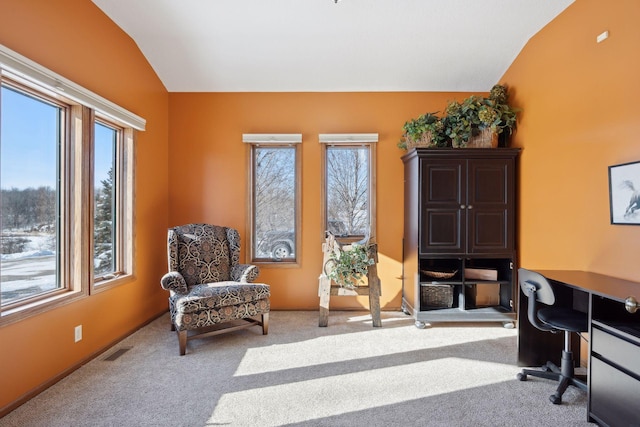 office with vaulted ceiling, baseboards, visible vents, and light colored carpet