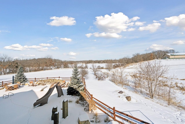 yard covered in snow with fence