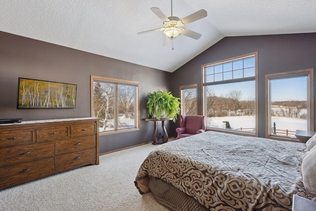 bedroom with light carpet, ceiling fan, multiple windows, and vaulted ceiling