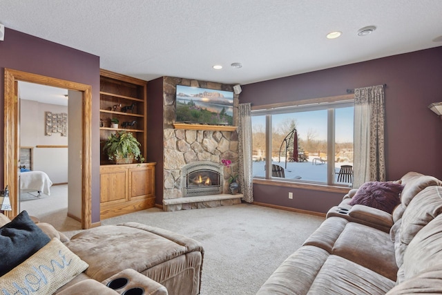 living room with recessed lighting, light carpet, a stone fireplace, a textured ceiling, and baseboards