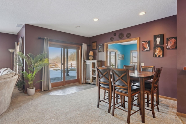 dining space with recessed lighting, baseboards, light colored carpet, a textured ceiling, and light tile patterned flooring