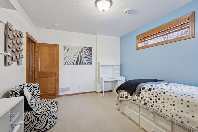 bedroom with light carpet, baseboards, visible vents, and a textured ceiling