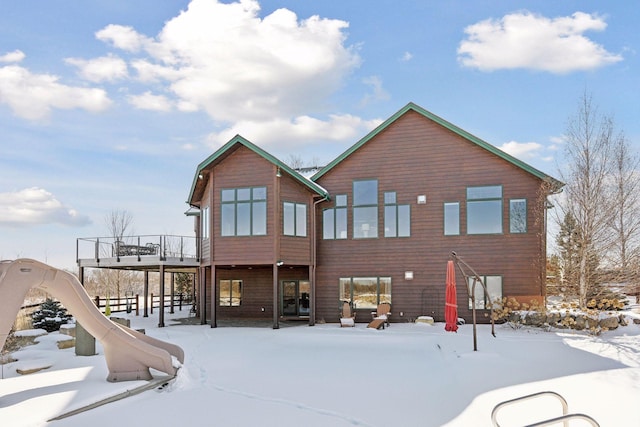 view of snow covered rear of property