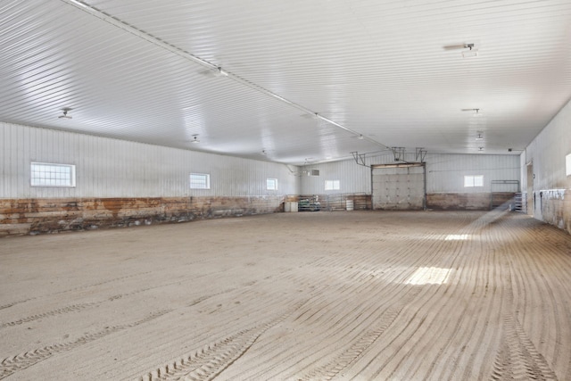 misc room with metal wall and vaulted ceiling