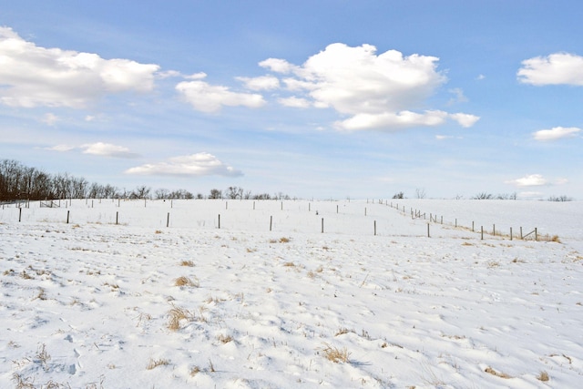 snowy yard featuring a rural view