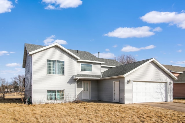 view of front of property with an attached garage, driveway, and roof with shingles