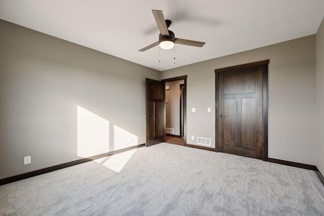 unfurnished bedroom featuring ceiling fan and carpet