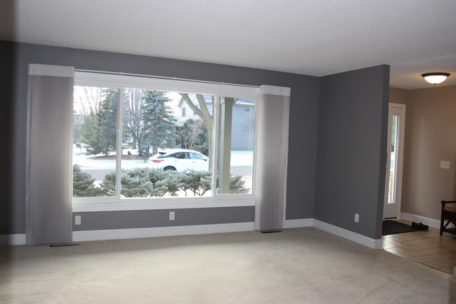 unfurnished room with light tile patterned floors and a healthy amount of sunlight