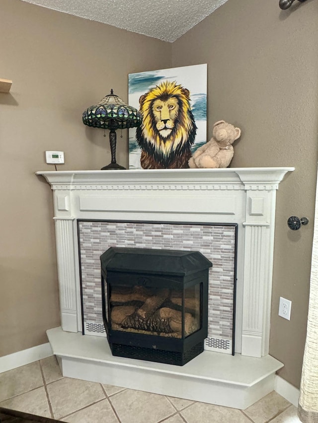 interior details with a tile fireplace and a textured ceiling