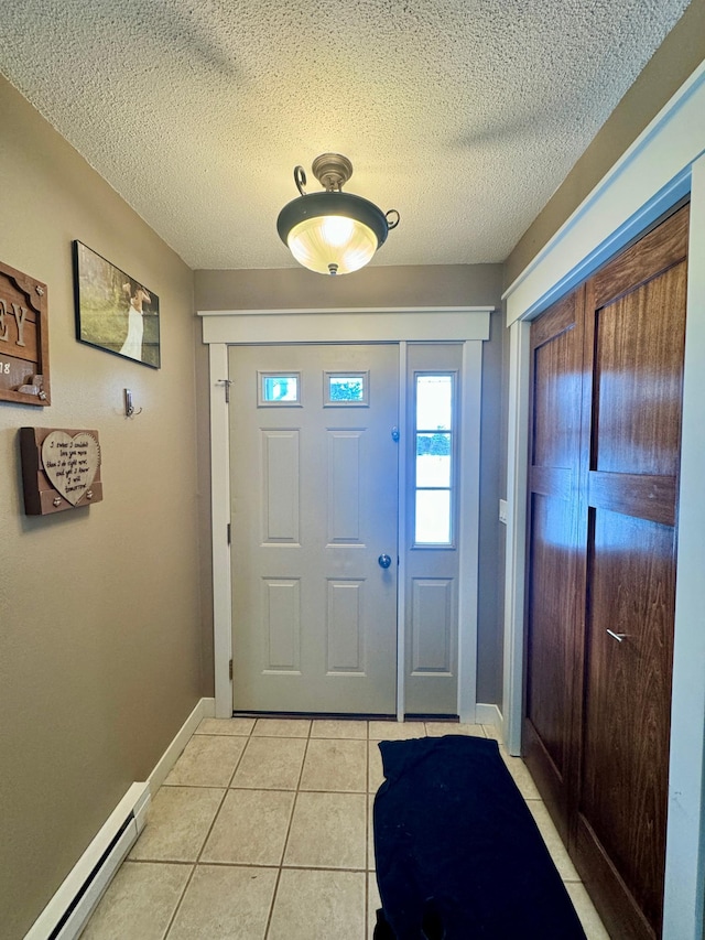 tiled entrance foyer featuring a baseboard radiator and a textured ceiling