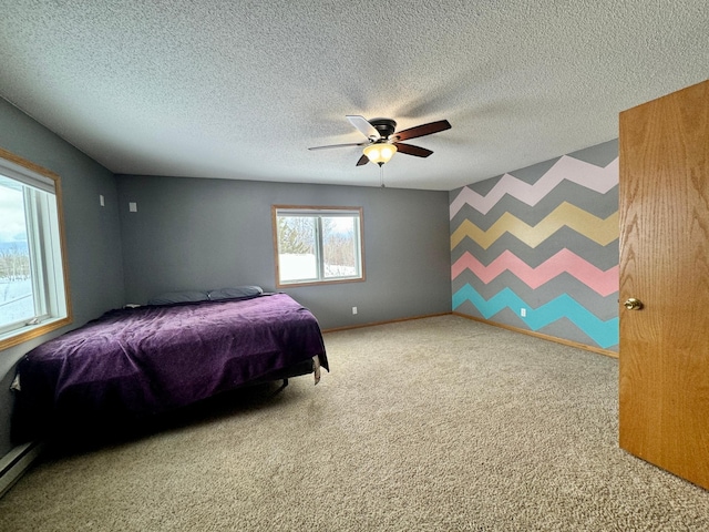 bedroom with baseboard heating, a textured ceiling, ceiling fan, and carpet flooring