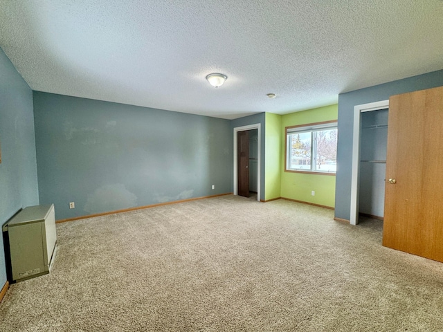 unfurnished bedroom with light colored carpet and a textured ceiling