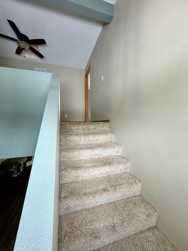 staircase with beamed ceiling and ceiling fan