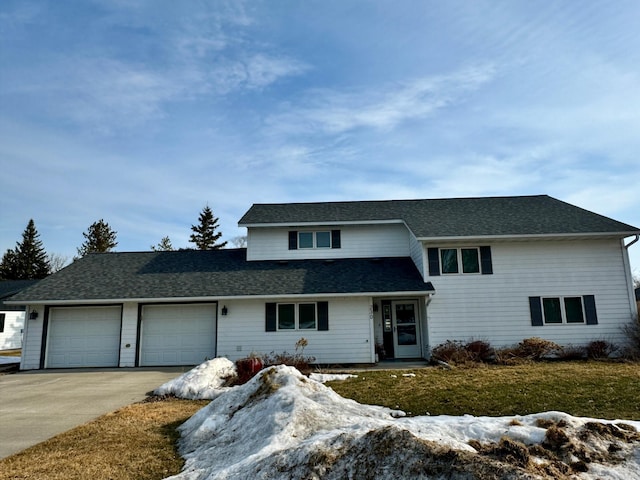 view of front of home featuring an attached garage, a shingled roof, and driveway