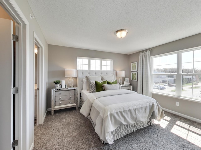 bedroom with carpet flooring and a textured ceiling