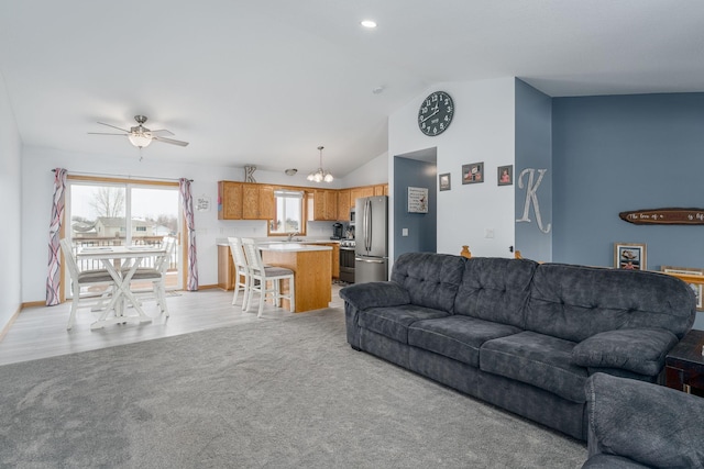 carpeted living room featuring vaulted ceiling and ceiling fan