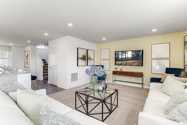 living room featuring a textured ceiling and carpet flooring