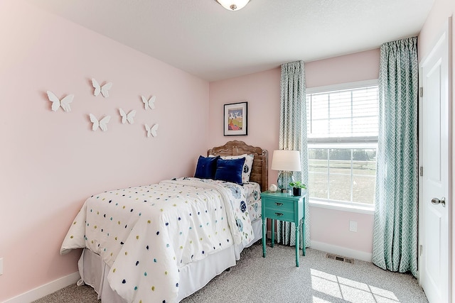 bedroom featuring carpet floors and multiple windows