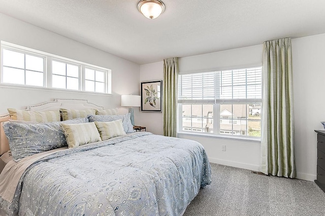 bedroom with carpet floors and multiple windows