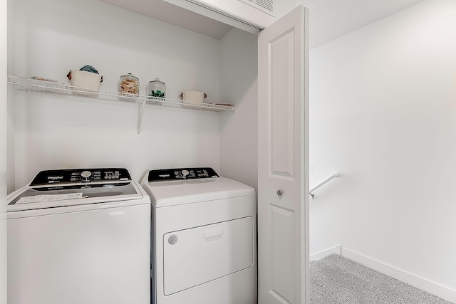 clothes washing area featuring washer and dryer and carpet floors