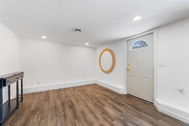 entrance foyer featuring dark wood-type flooring and a textured ceiling