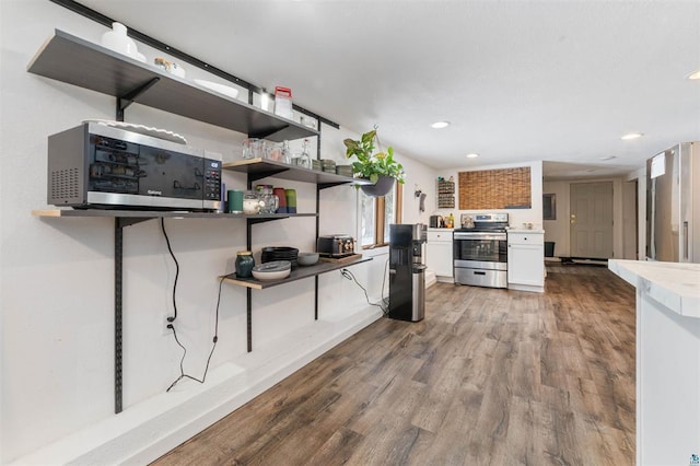 kitchen featuring hardwood / wood-style flooring, appliances with stainless steel finishes, and white cabinets