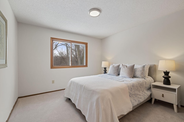 carpeted bedroom featuring a textured ceiling