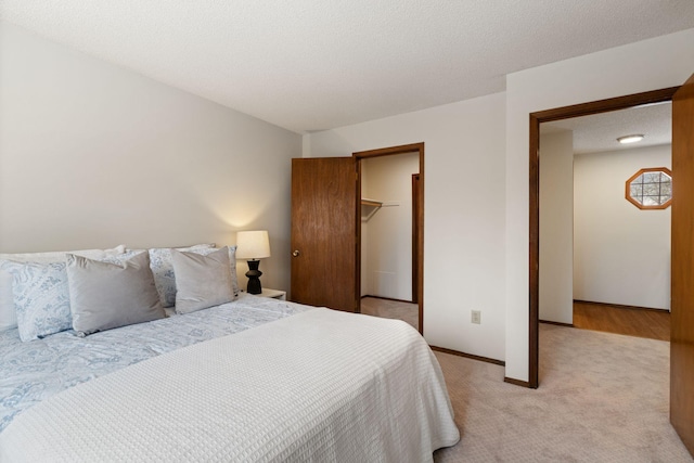 carpeted bedroom with a closet and a textured ceiling