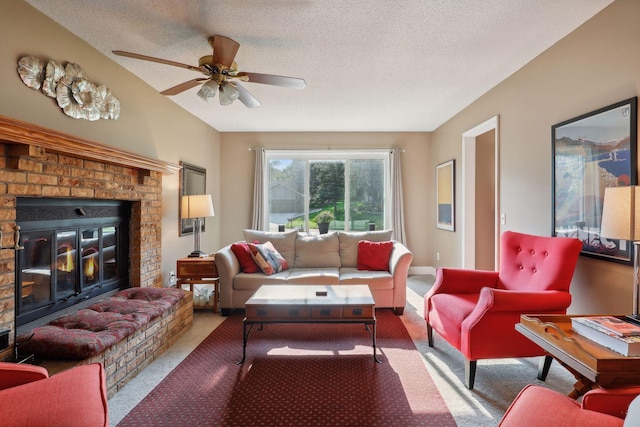 carpeted living room with ceiling fan, a textured ceiling, and a fireplace