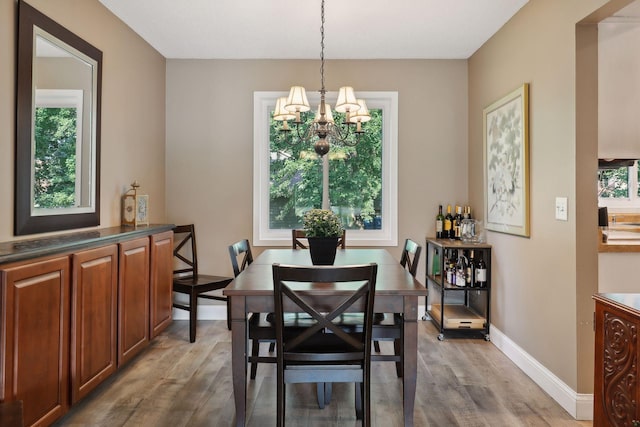 dining space with an inviting chandelier and hardwood / wood-style floors