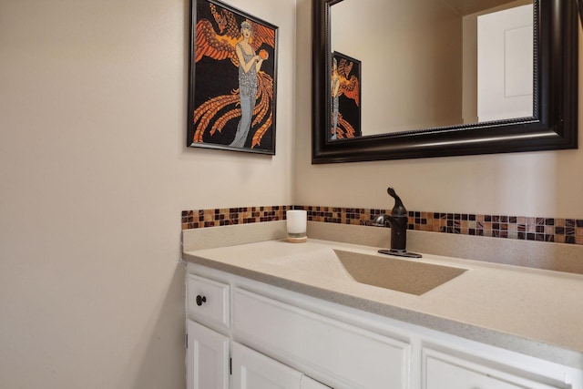 bathroom featuring vanity and decorative backsplash