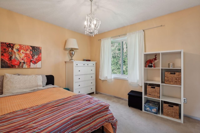 bedroom with a textured ceiling, light colored carpet, and a chandelier