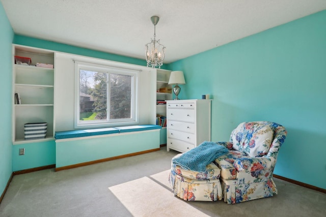 sitting room featuring light carpet and a notable chandelier