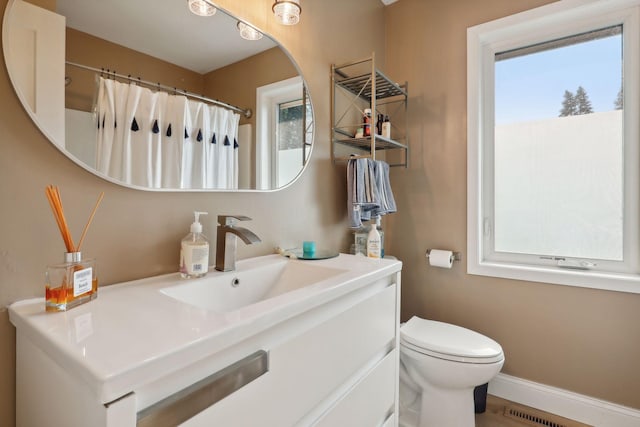 bathroom with vanity, toilet, and walk in shower