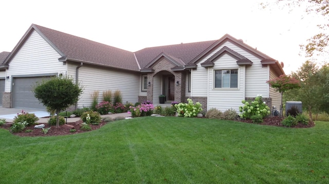 view of front of house featuring a garage and a front lawn