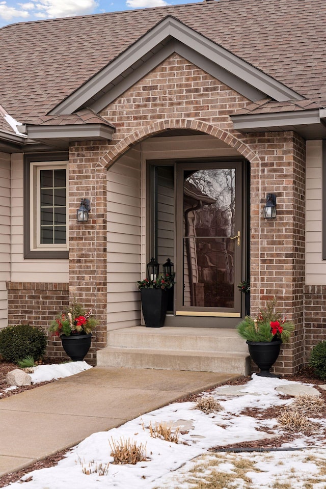 view of snow covered property entrance