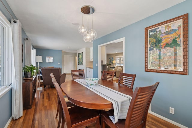 dining area with dark wood-type flooring