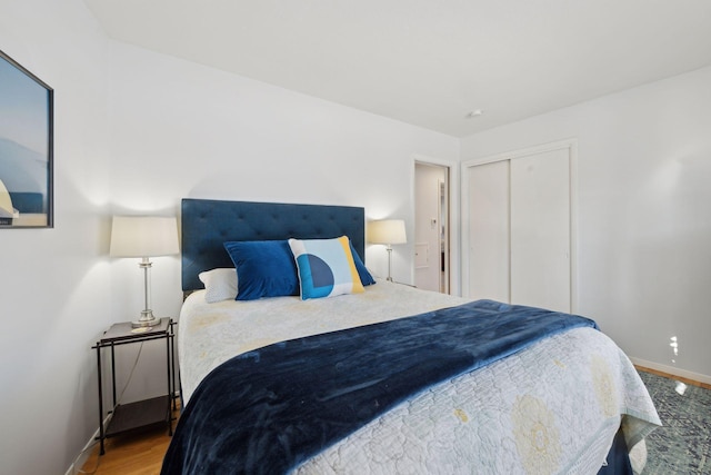 bedroom featuring hardwood / wood-style flooring and a closet