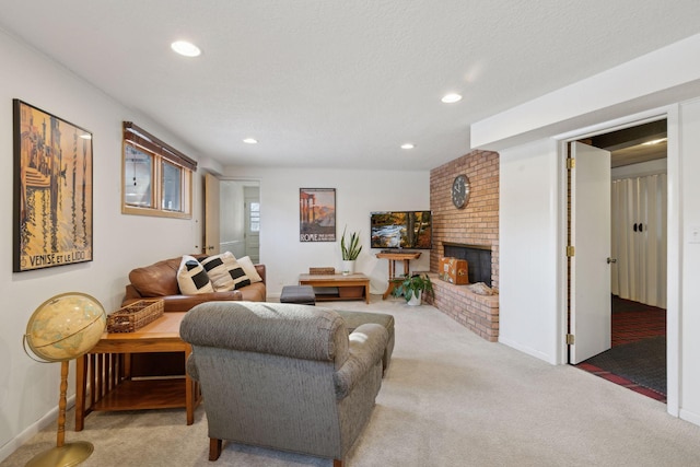 carpeted living room featuring a brick fireplace and a textured ceiling