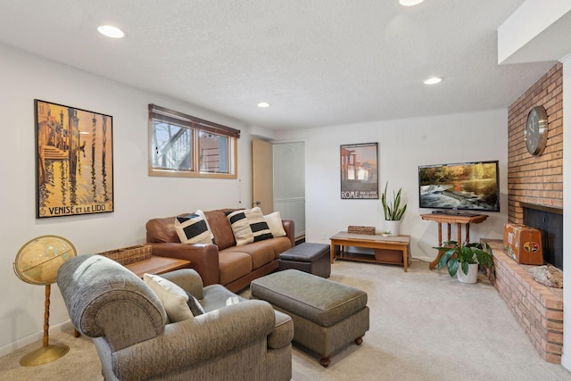 carpeted living room featuring a brick fireplace and a textured ceiling