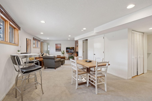 carpeted dining area featuring a textured ceiling