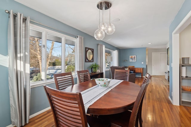 dining room with light wood-style flooring and baseboards