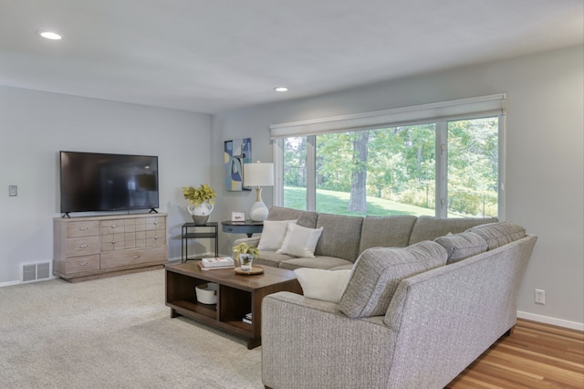 living room featuring wood finished floors, recessed lighting, baseboards, and visible vents